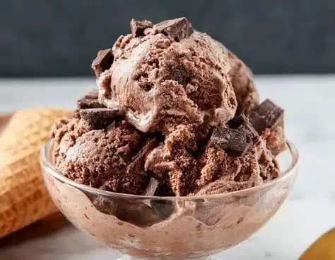 Decadent chocolate ice cream in a scoop on a cone