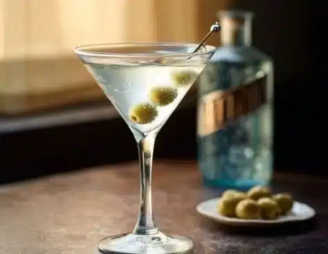 A refreshing homemade gin martini garnished with an olive.