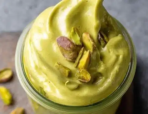 Delicious and creamy pistachio cream jar with a spoon