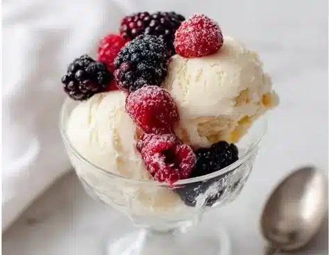 Bowl of protein-packed ice cream topped with nuts and berries