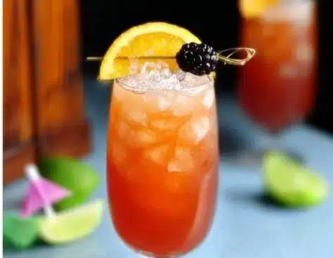 Rum Runner Cocktail 4 Delicious Rum Runner cocktail garnished with fruit slices in a glass.