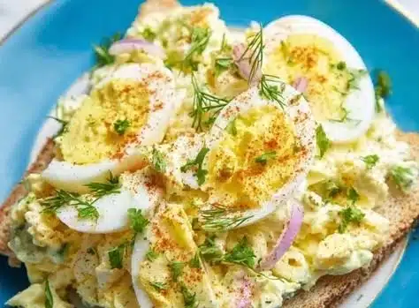 Foolproof egg salad in a bowl garnished with parsley